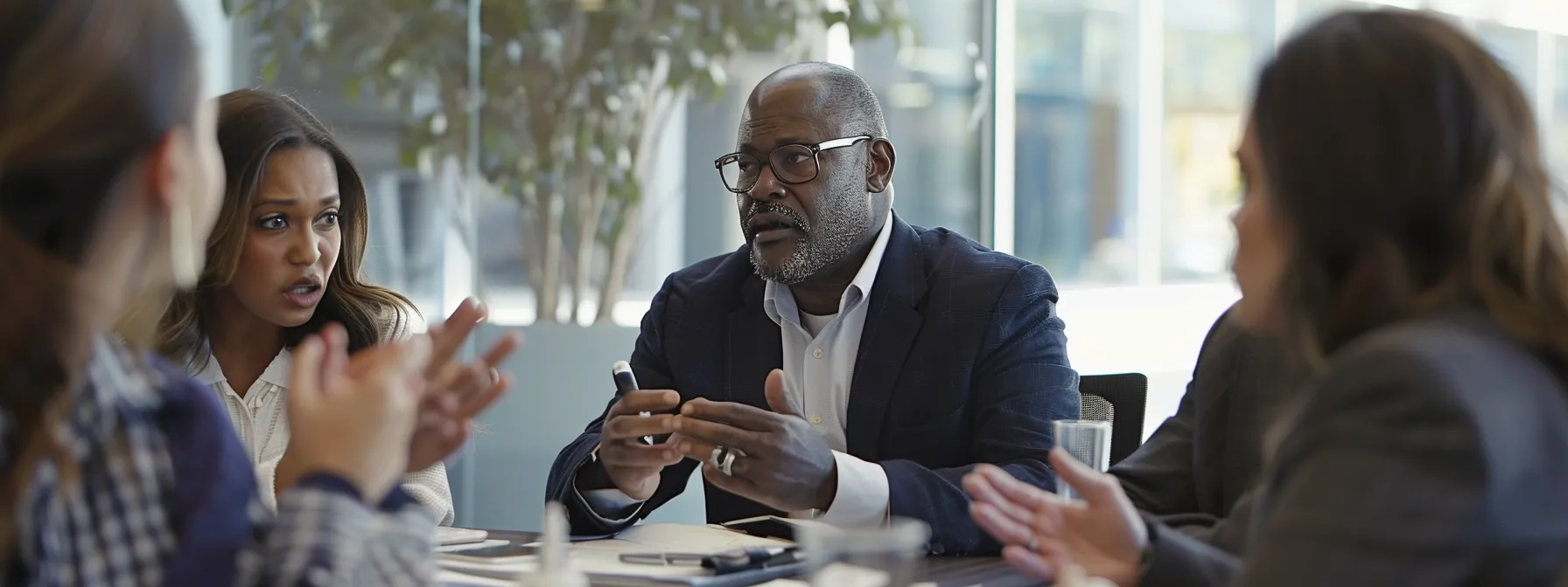 a group of professionals discussing social media strategies in a modern office boardroom.