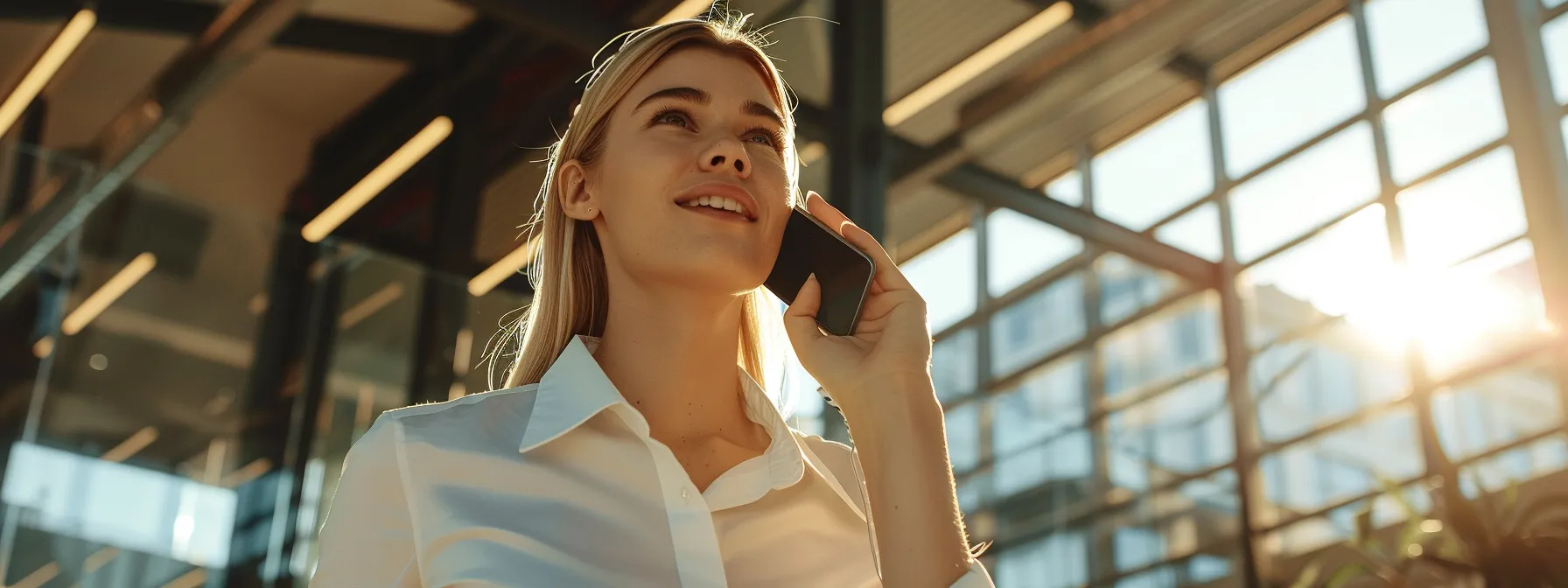 a salesperson confidently talking on the phone in a modern office space.