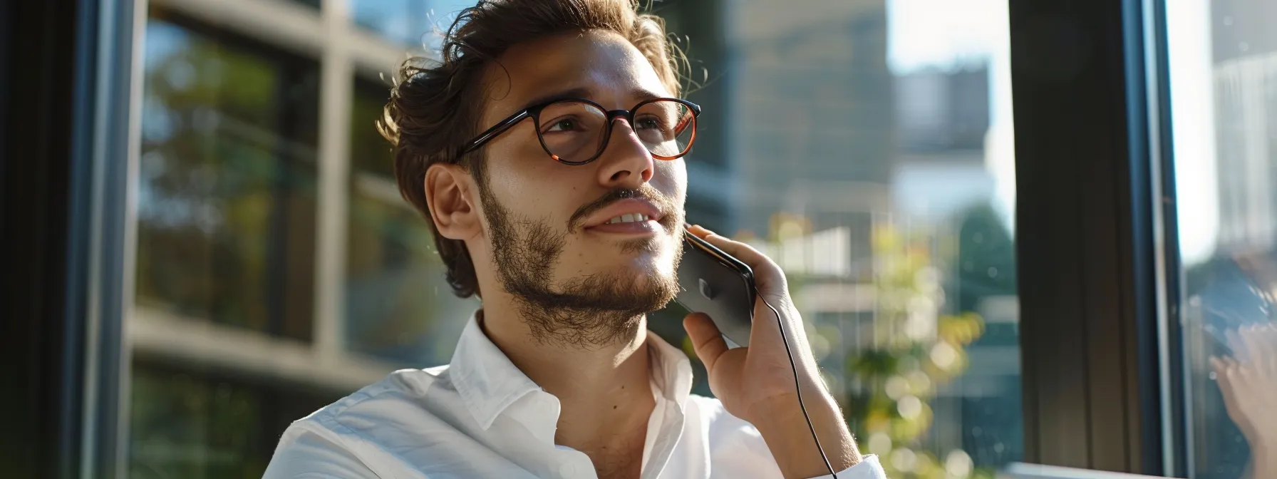 a salesperson on the phone, gesturing confidently while listening to a potential client's objections.