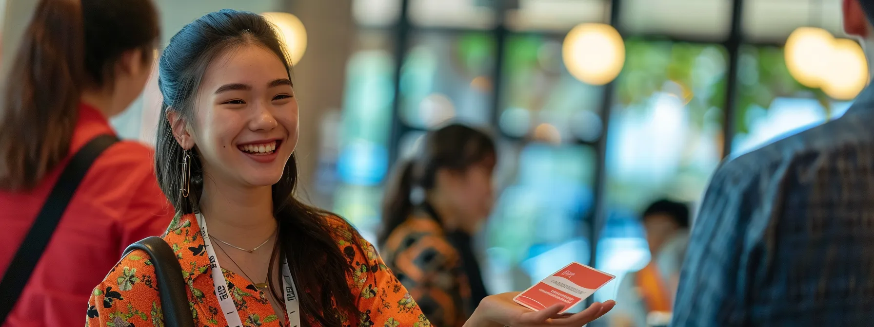 a woman smiling confidently while handing out business cards at a networking event in melbourne.